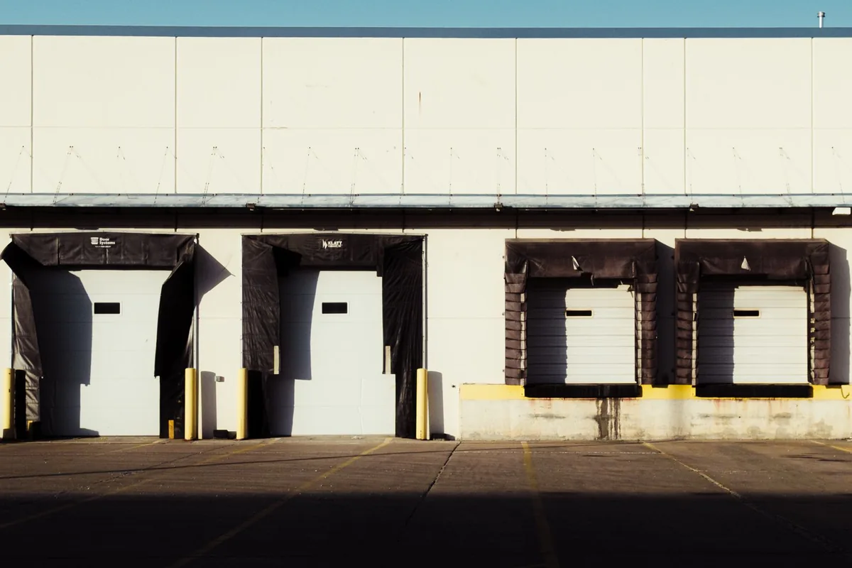 A row of commercial loading bays in daylight.